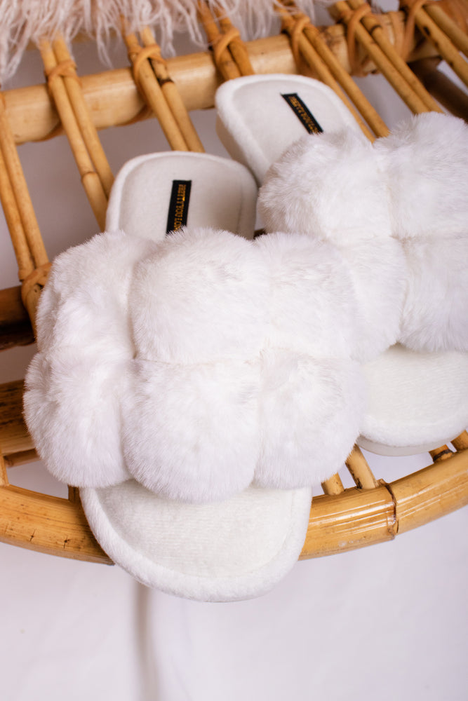 
                  
                    Dolly women's slider slippers in white with oversized faux fur pom poms from Pretty You London
                  
                