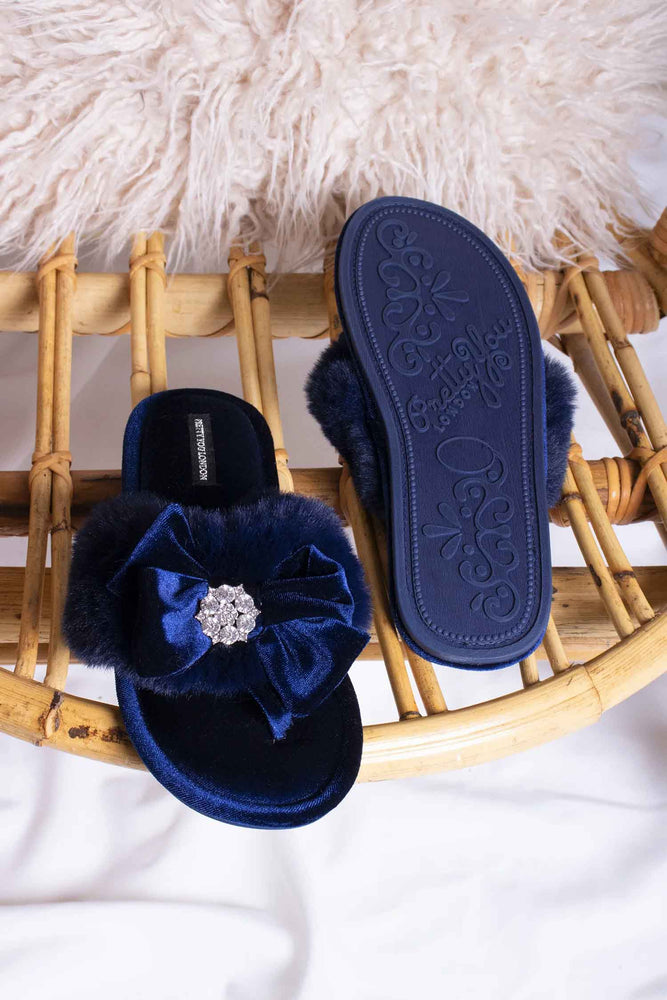 
                  
                    Amelie women's toe post slippers in navy with a premium velvet bow and diamante embellishment atop a plush faux fur band from Pretty You London
                  
                