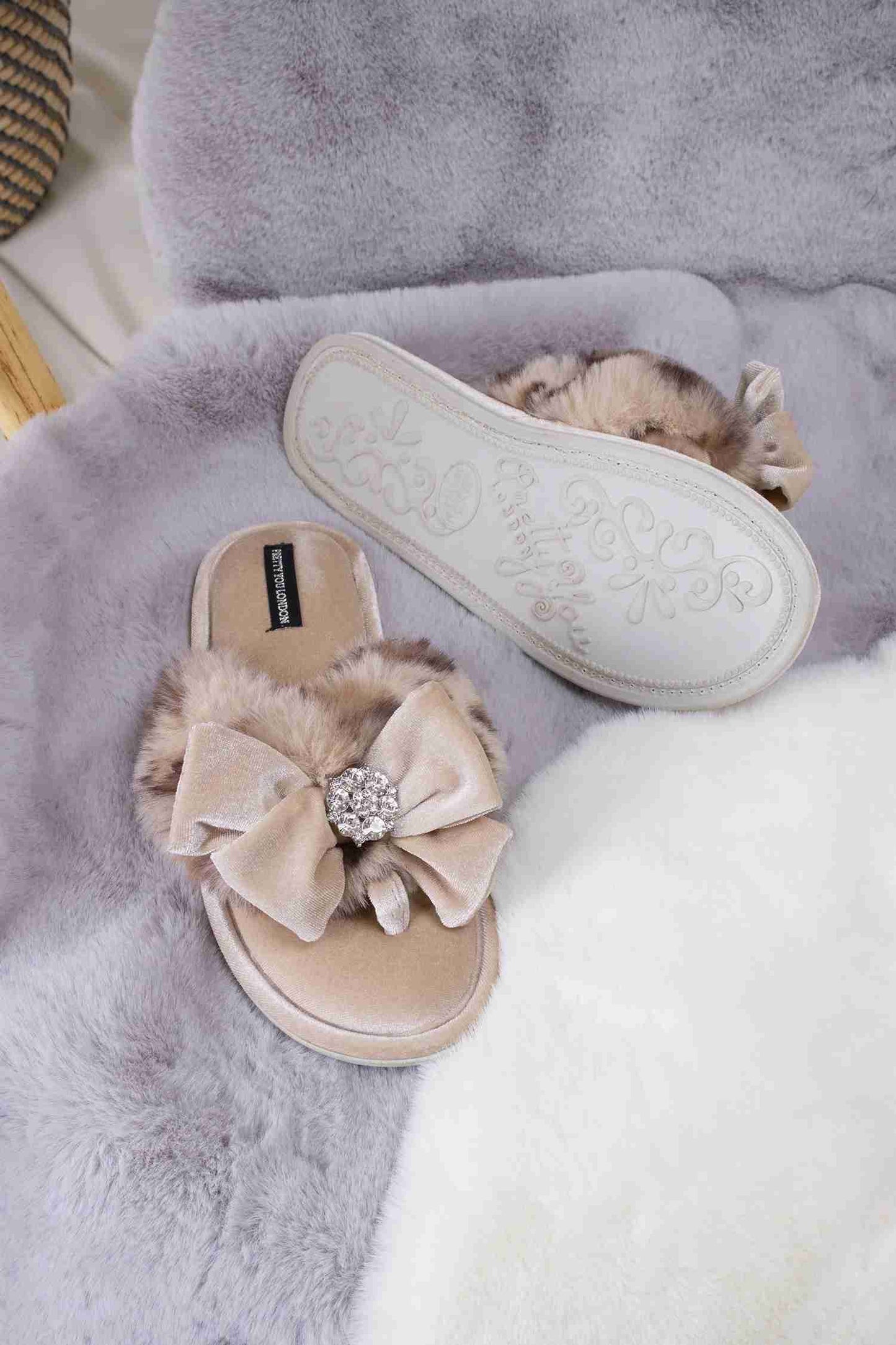 
                  
                    Amelie women's toe post slippers in leopard with a premium velvet bow and diamante embellishment atop a plush faux fur band from Pretty You London
                  
                