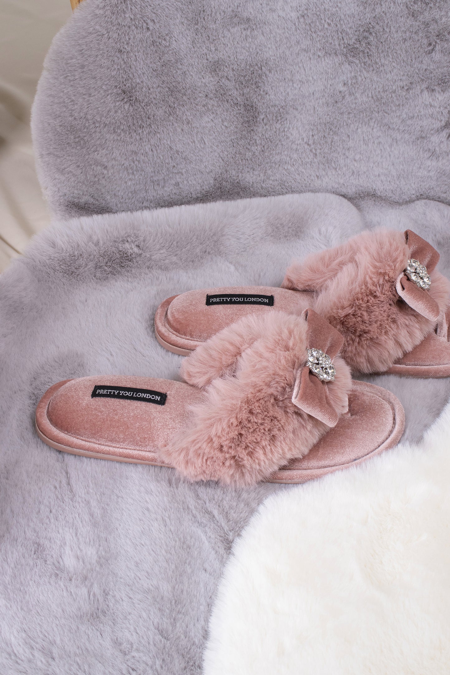 
                  
                    Amelie women's toe post slippers in pink with a premium velvet bow and diamante embellishment atop a plush faux fur band from Pretty You London
                  
                