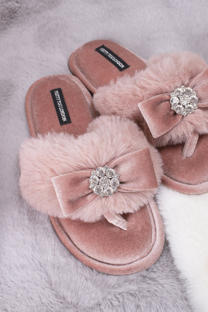 
                  
                    Amelie women's toe post slippers in pink with a premium velvet bow and diamante embellishment atop a plush faux fur band from Pretty You London
                  
                