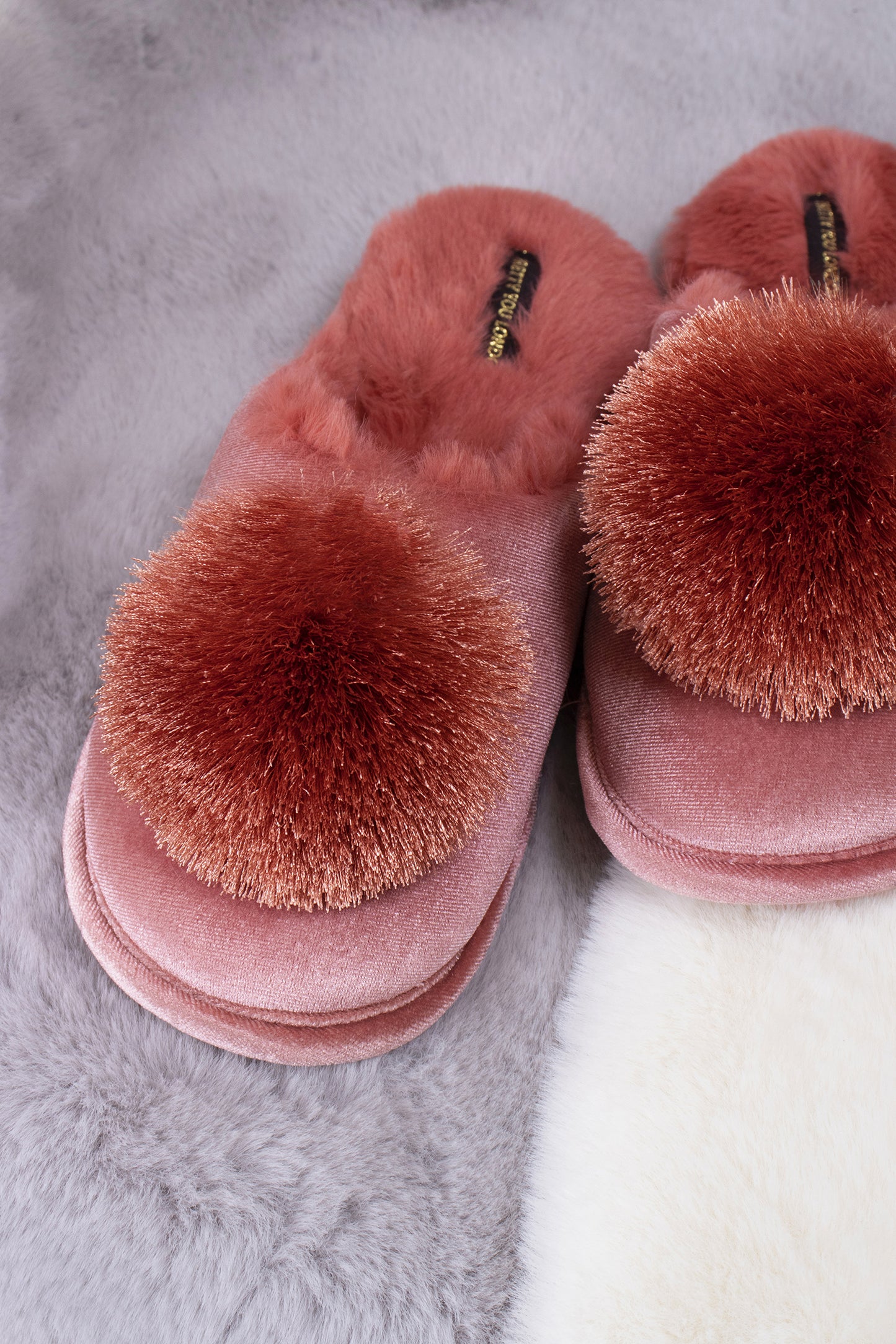 
                  
                    Coco women's mule slippers in terracotta with faux fur lining, velvet upper and finished with a satin fringe pom from Pretty You London
                  
                