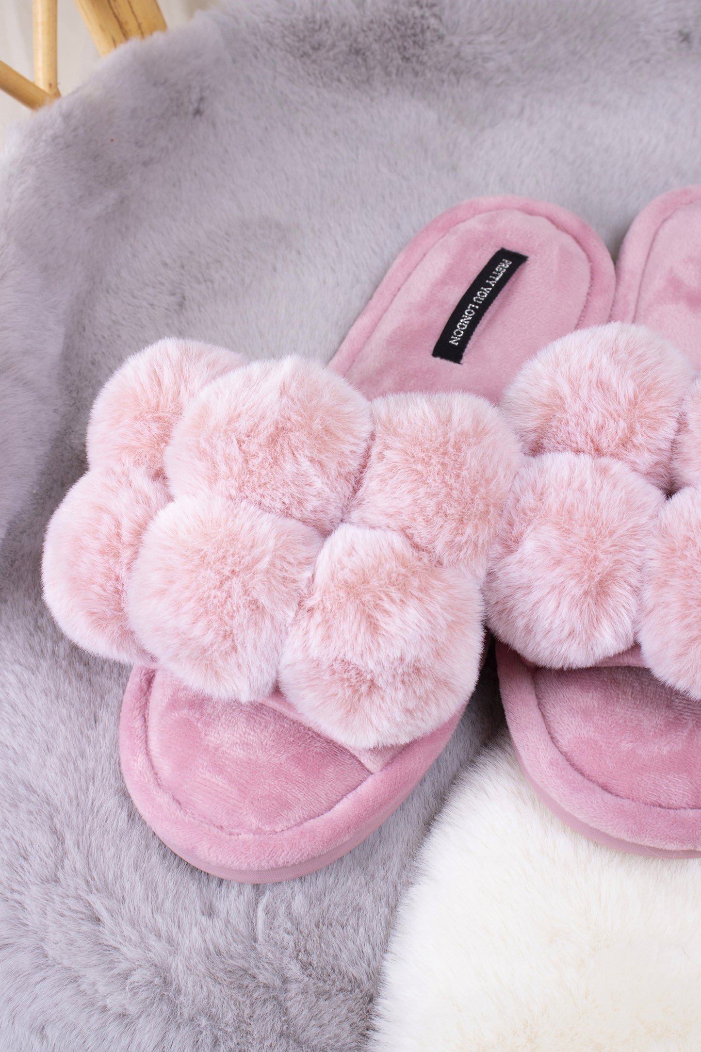 
                  
                    Dolly women's slider slippers in pink with oversized faux fur pom poms from Pretty You London
                  
                