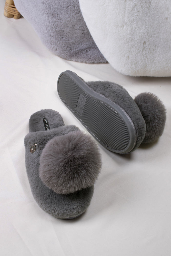 
                  
                    Etta women's mule slippers in grey with a statement oversized pom and metallic faux-suede binding from Pretty You London
                  
                